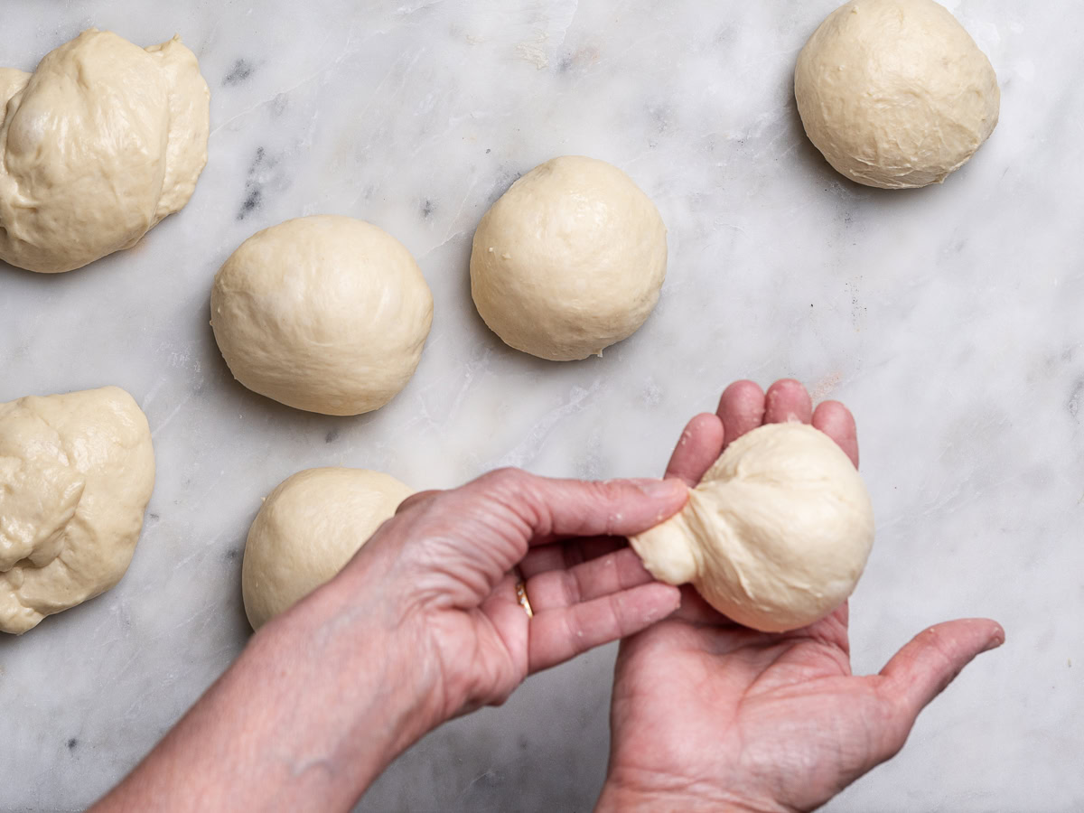 shaping dough pieces into balls