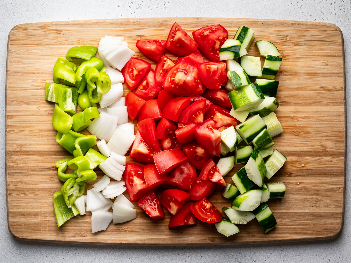 chopped vegetables laid out on cutting board