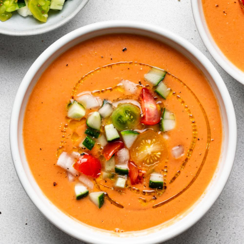 Gazpacho in bowls topped with garnishes