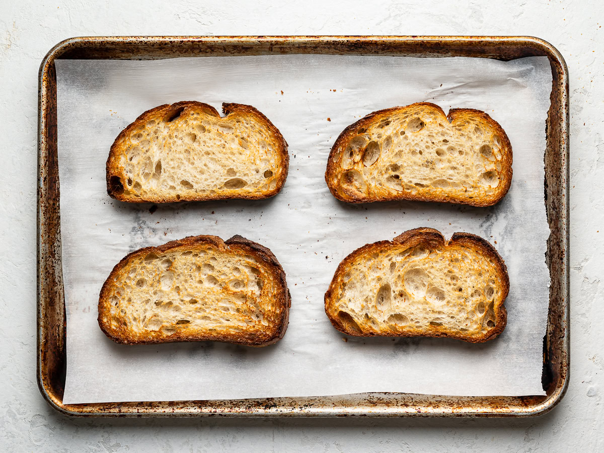 4 slices of bread toasted on a baking sheet