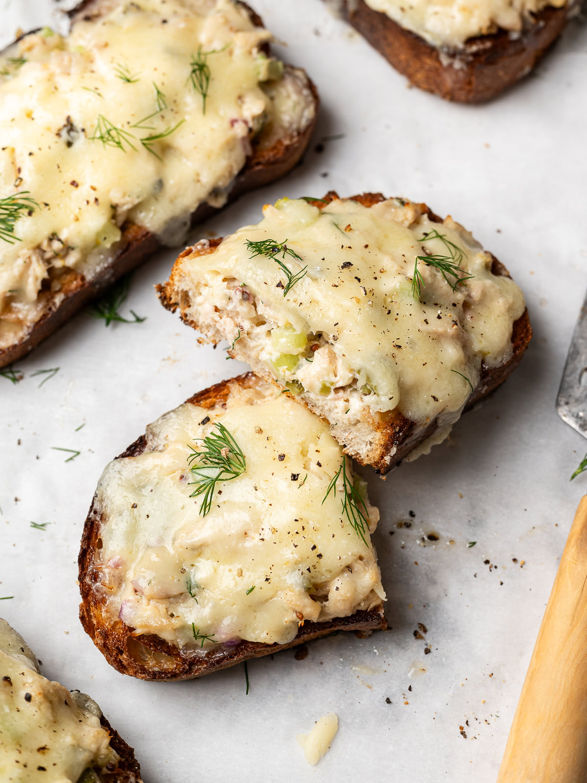 tuna melt on baking sheet sliced in half