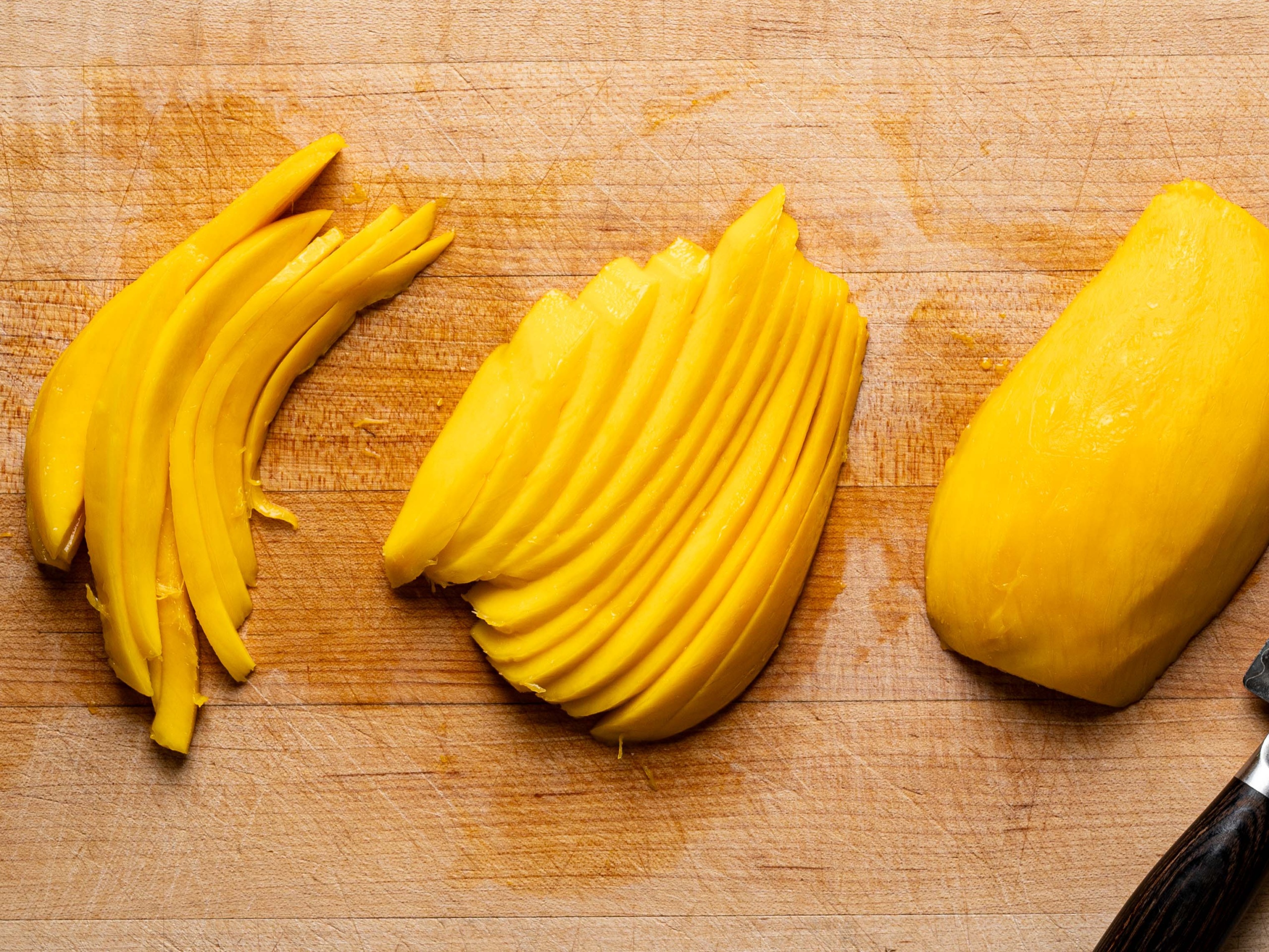 mango thinly sliced on cutting board