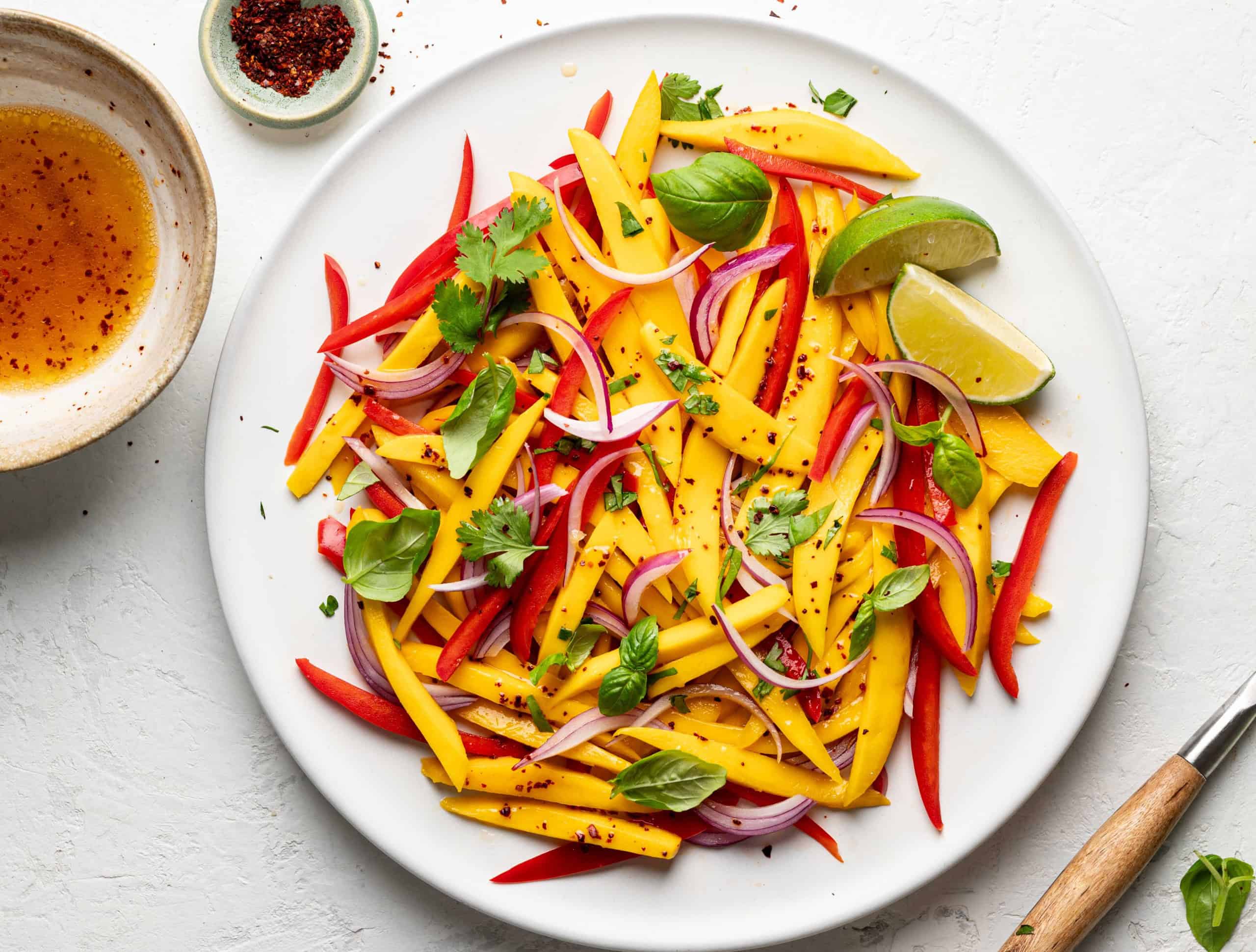 mango salad on platter drizzled with Aleppo pepper dressing