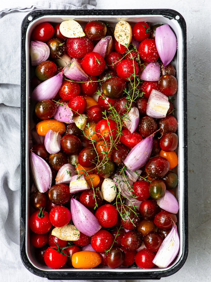 Cherry tomatoes, shallots and garlic in casserole