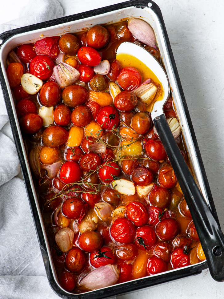 Cherry tomatoes, shallots and garlic in casserole, confit'd