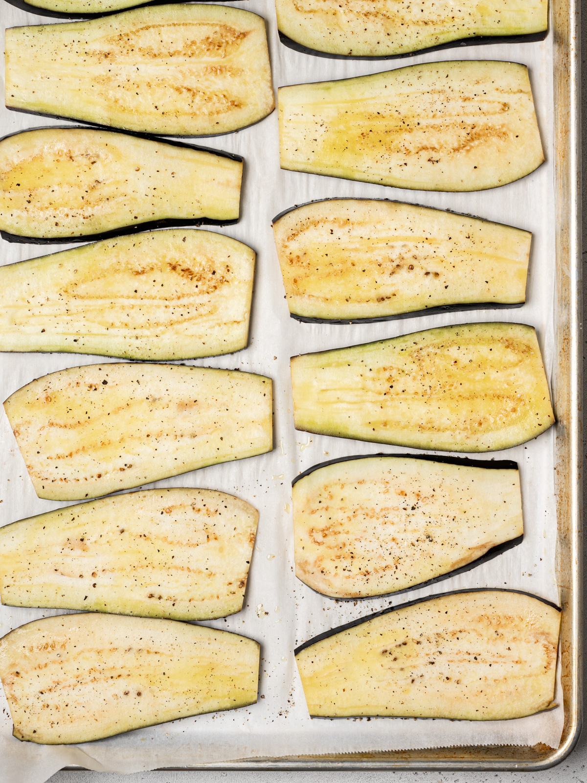 eggplant slices in a single layer on sheet pan ready to be baked