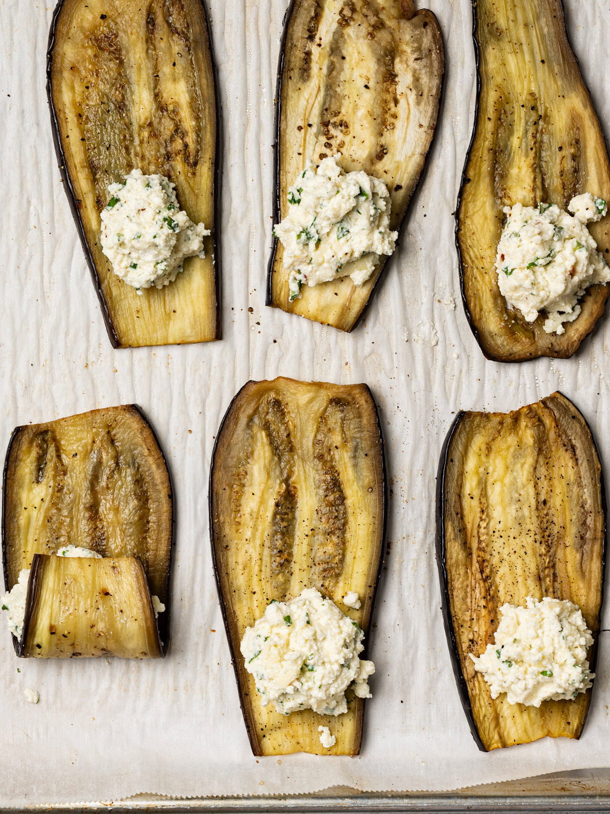 rolling eggplant slices around ricotta mixture