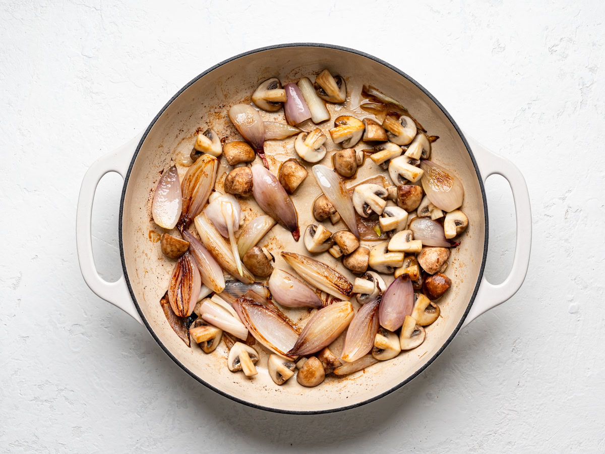 sautéed shallots and mushrooms in enamelled skillet