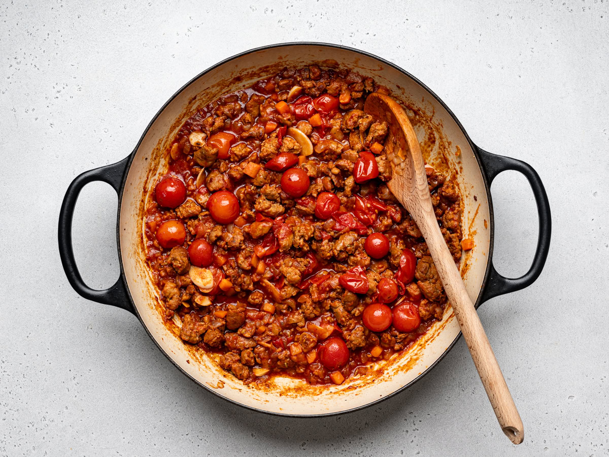 sausage mixture in skillet with the addition of canned tomatoes