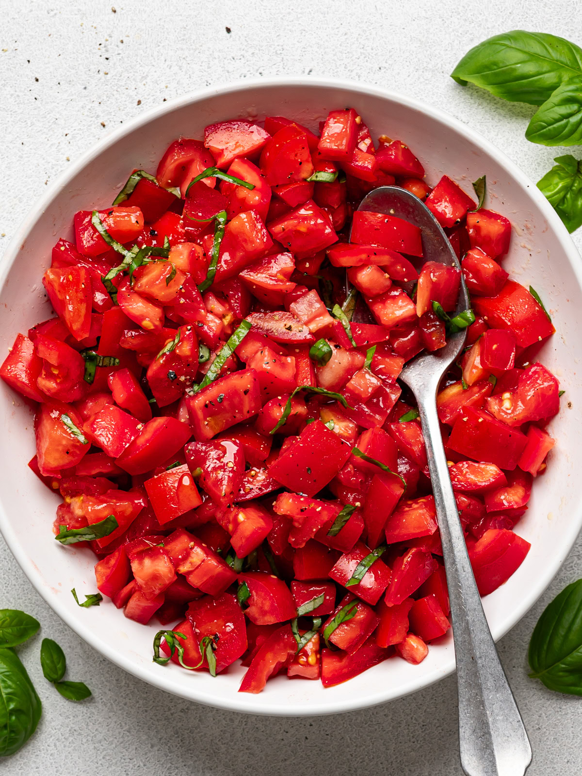 close-up image of tomato mixture in a white bowl 