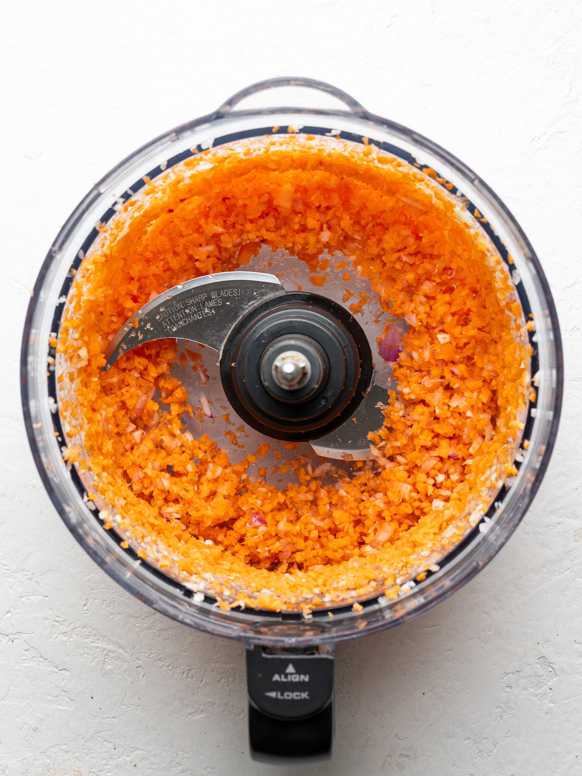 carrot and onion mixture blended in food processor bowl