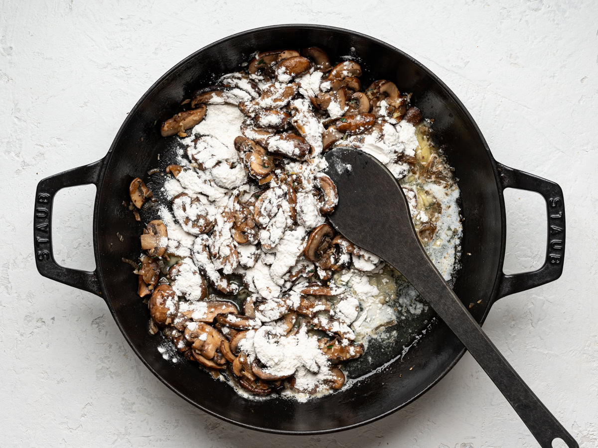 flour sprinkled over mushroom mixture in skillet