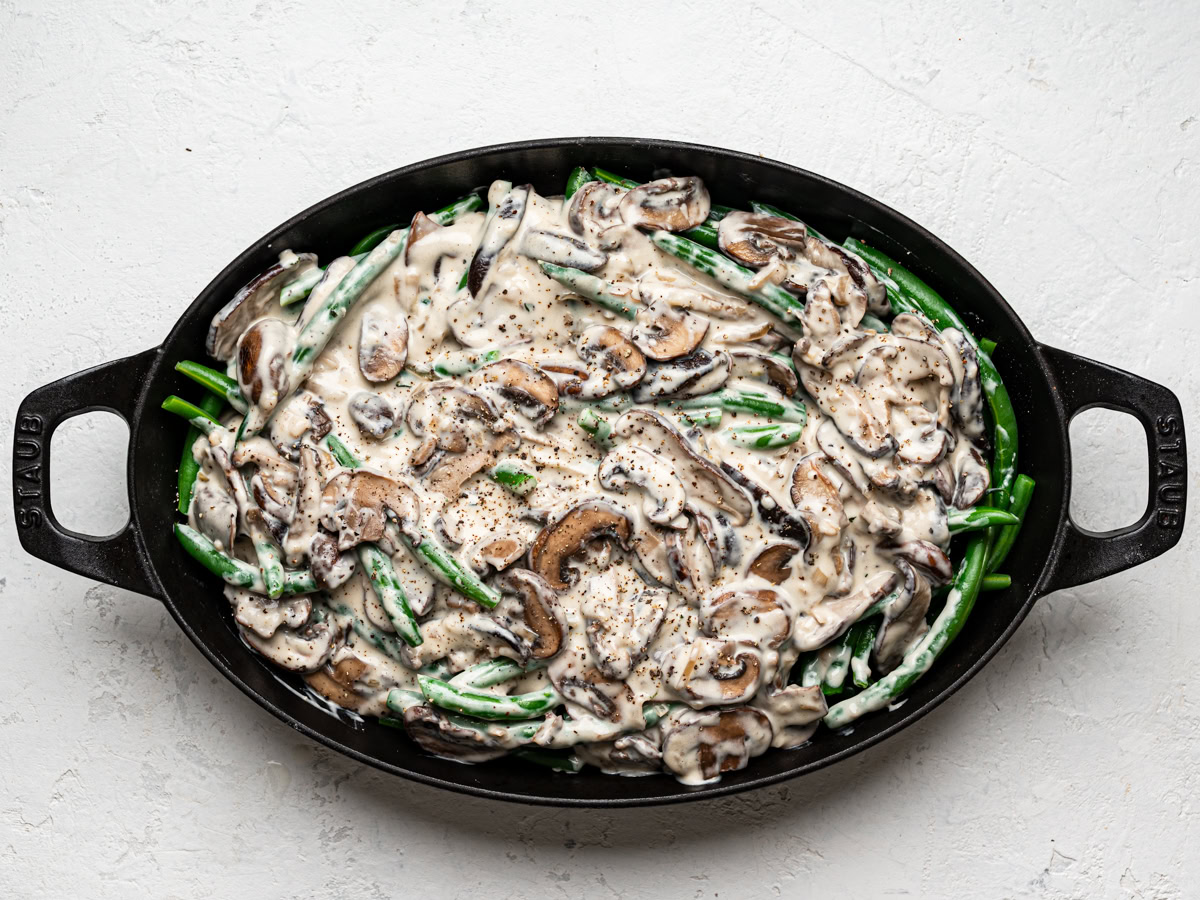 green beans tossed with creamy mushroom sauce in casserole