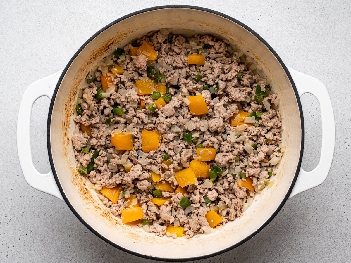 browned ground turkey in large white pot with vegetables