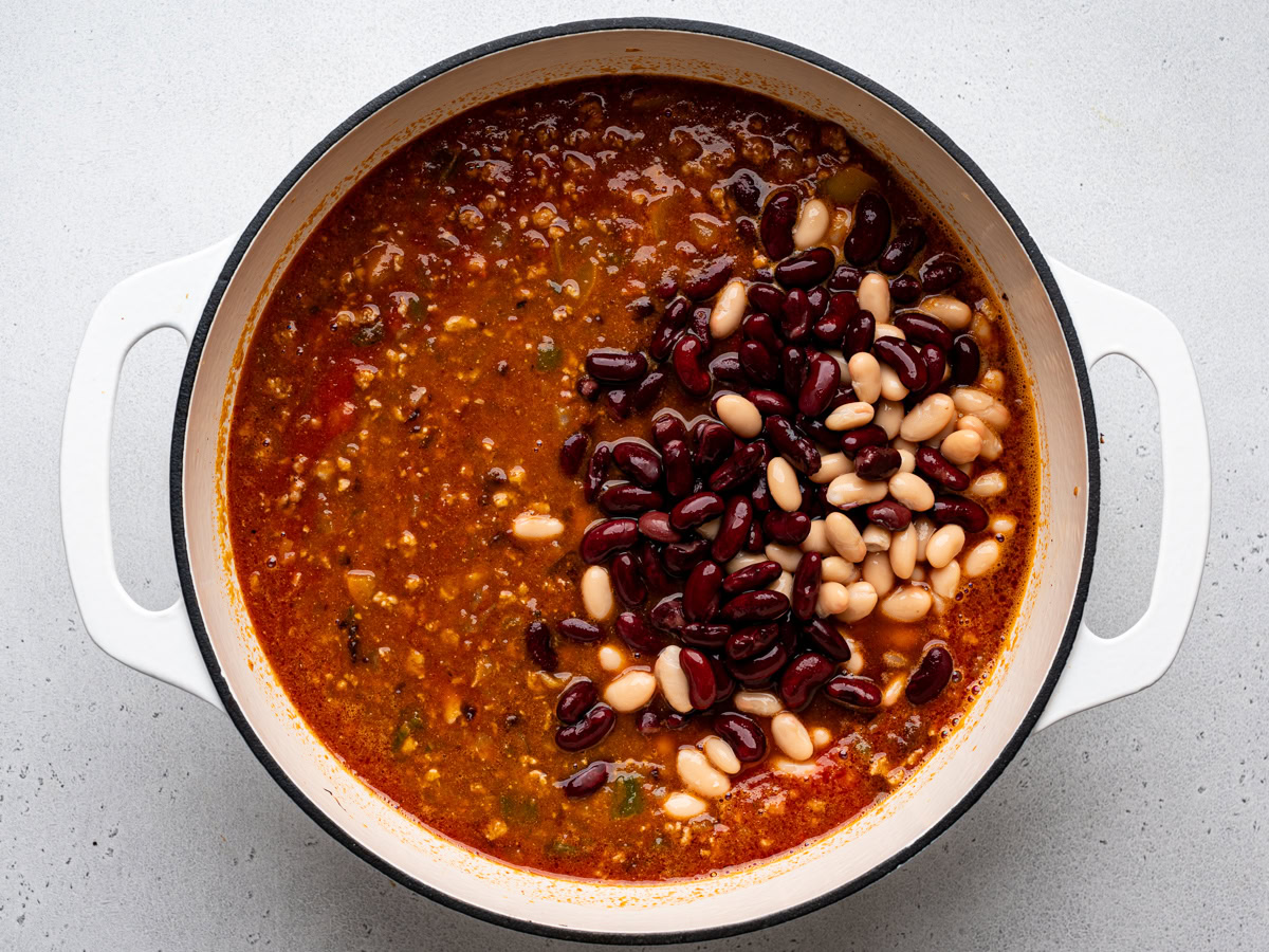 white beans and kidney beans added to the pot of chili