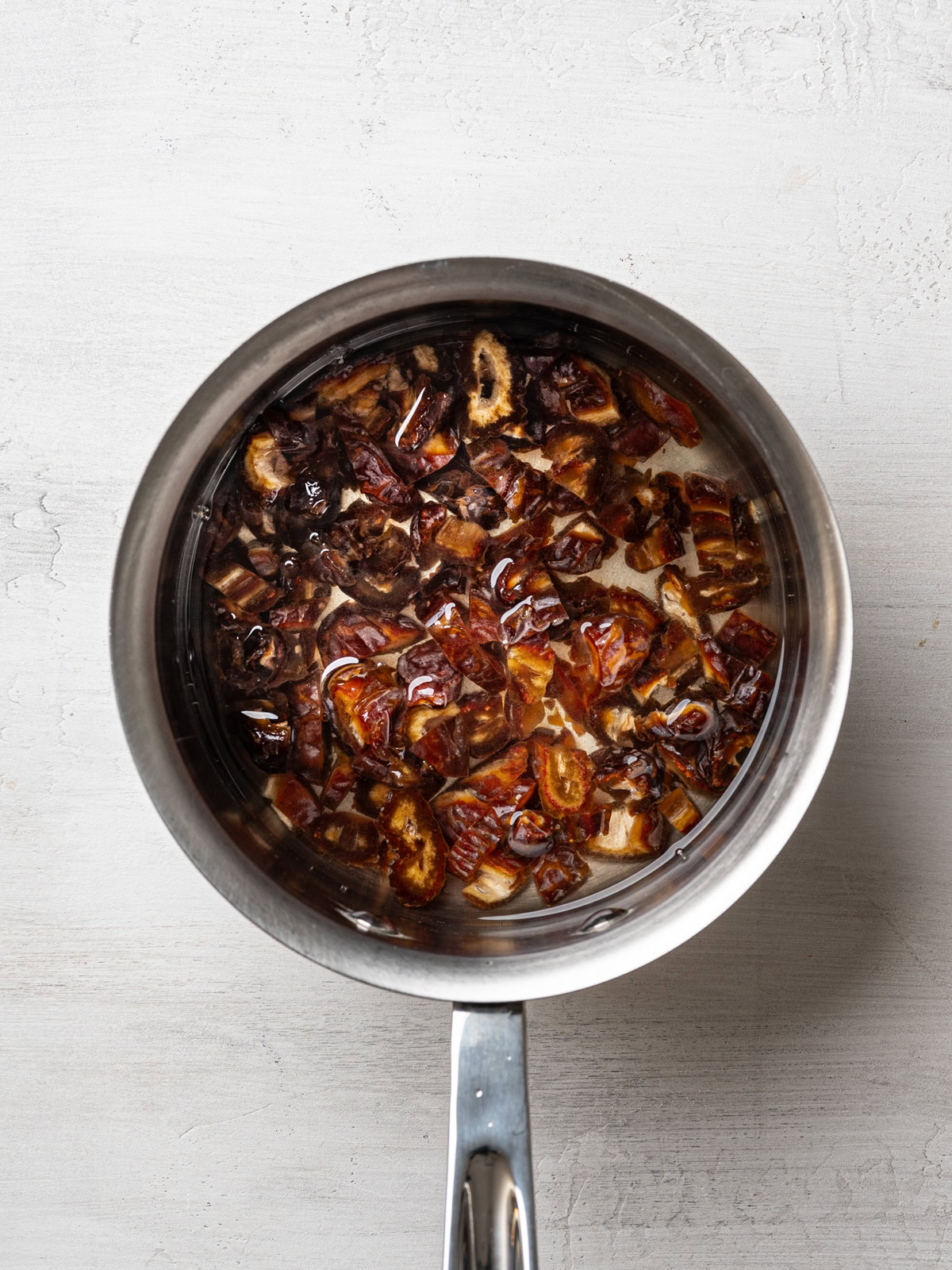 chopped dates and water in saucepan about to be boiled