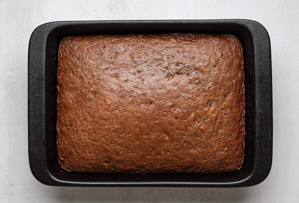 baked sticky toffee pudding cake in black baking dish