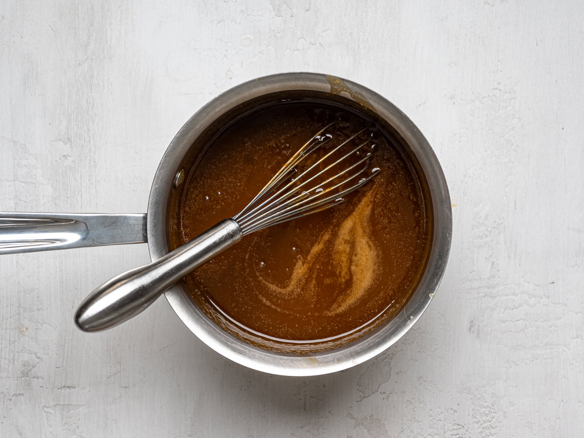 toffee sauce in saucepan with a whisk