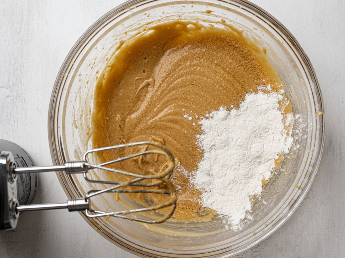  adding flour mixture to beaten butter mixture