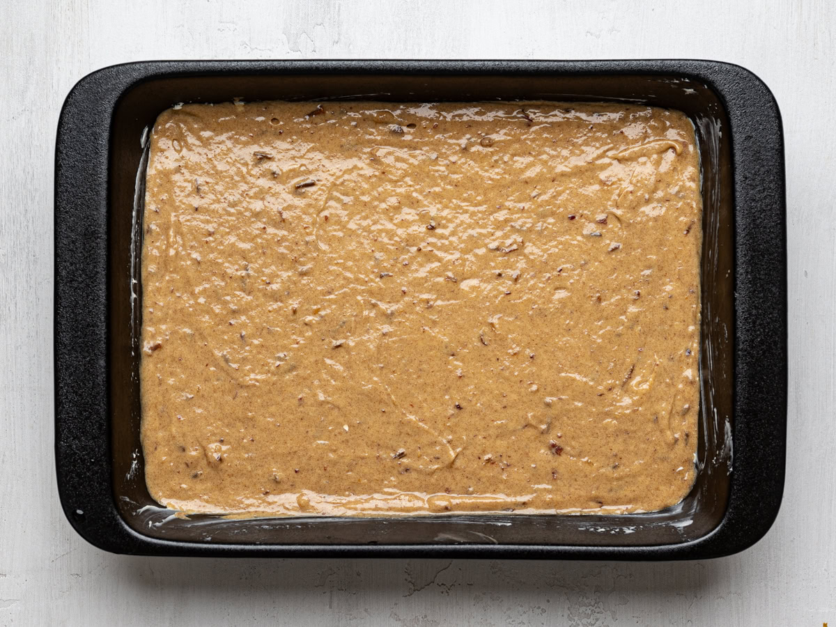 cake batter in black baking dish