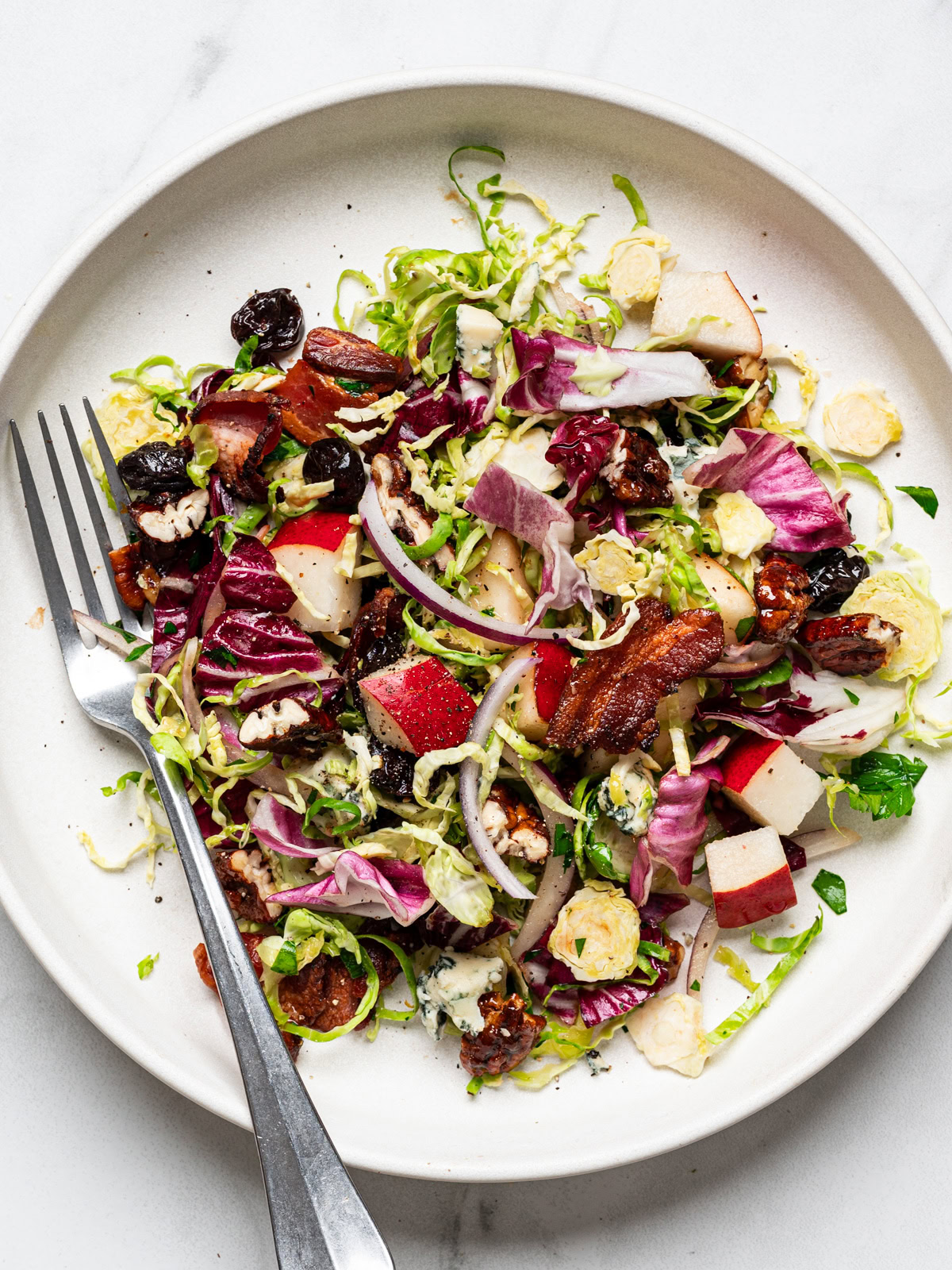 winter chopped salad served on a white plate with fork