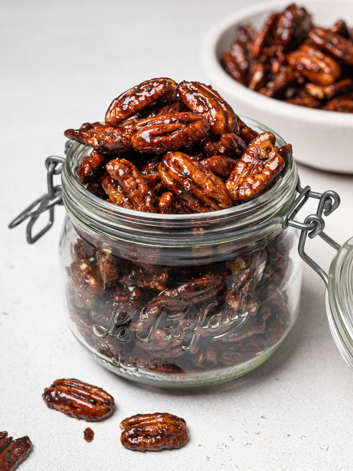 side view of candied pecans in mason jar