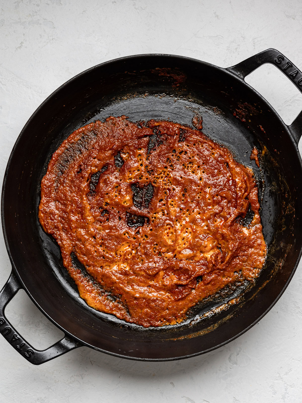 curry paste mixed with coconut milk in skillet