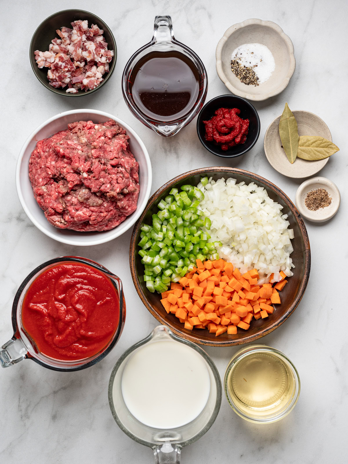 ingredients for the bolognese sauce prepared in small bowls