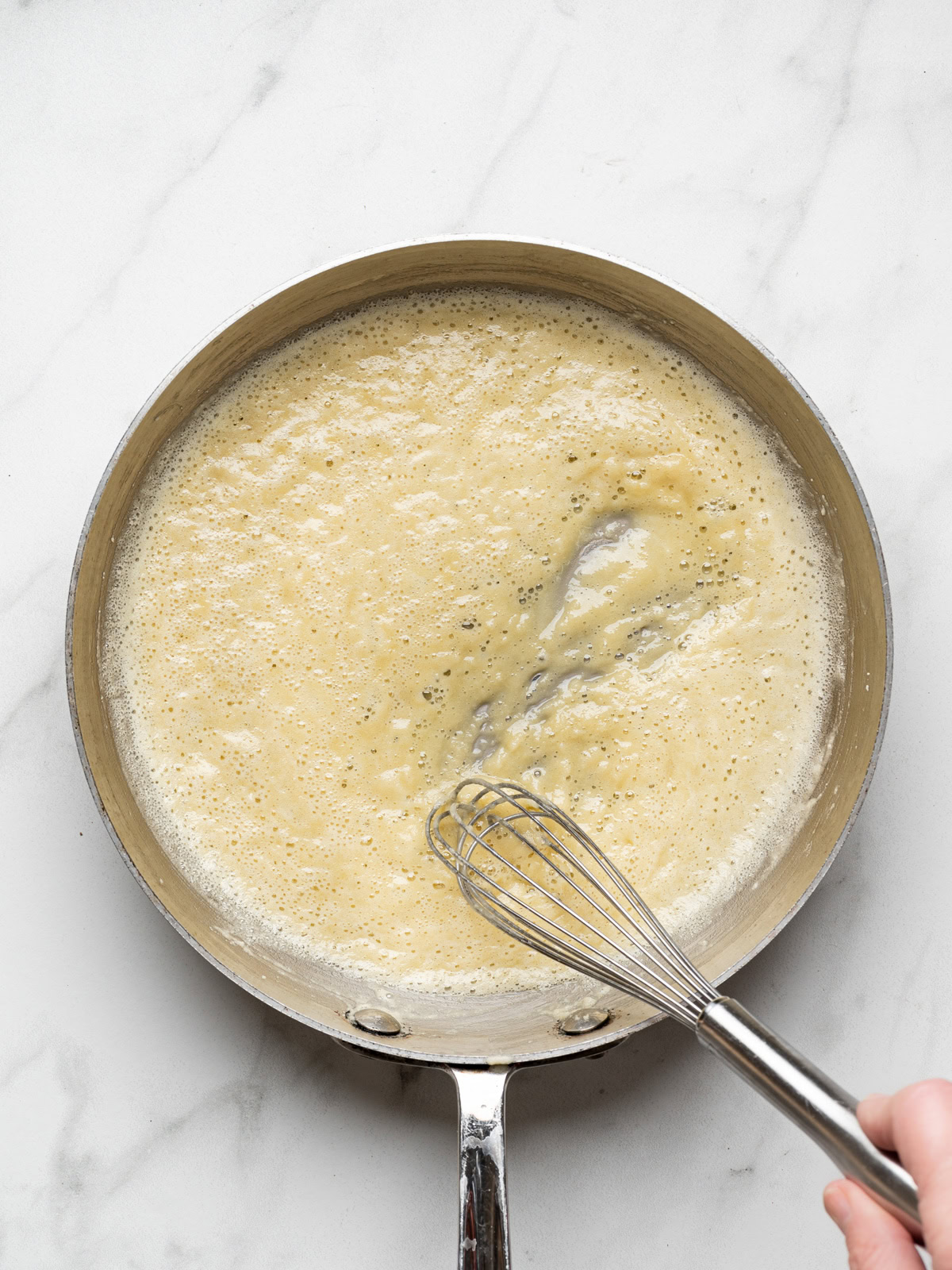 whisk whisking butter and flour to form a paste for bechamel sauce