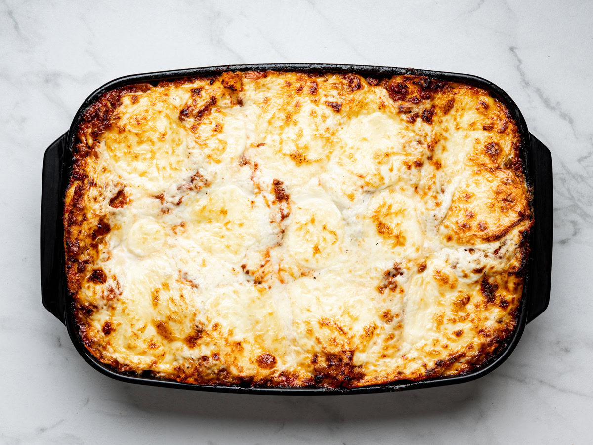 baked lasagna al forno in a black baking dish just out of the oven