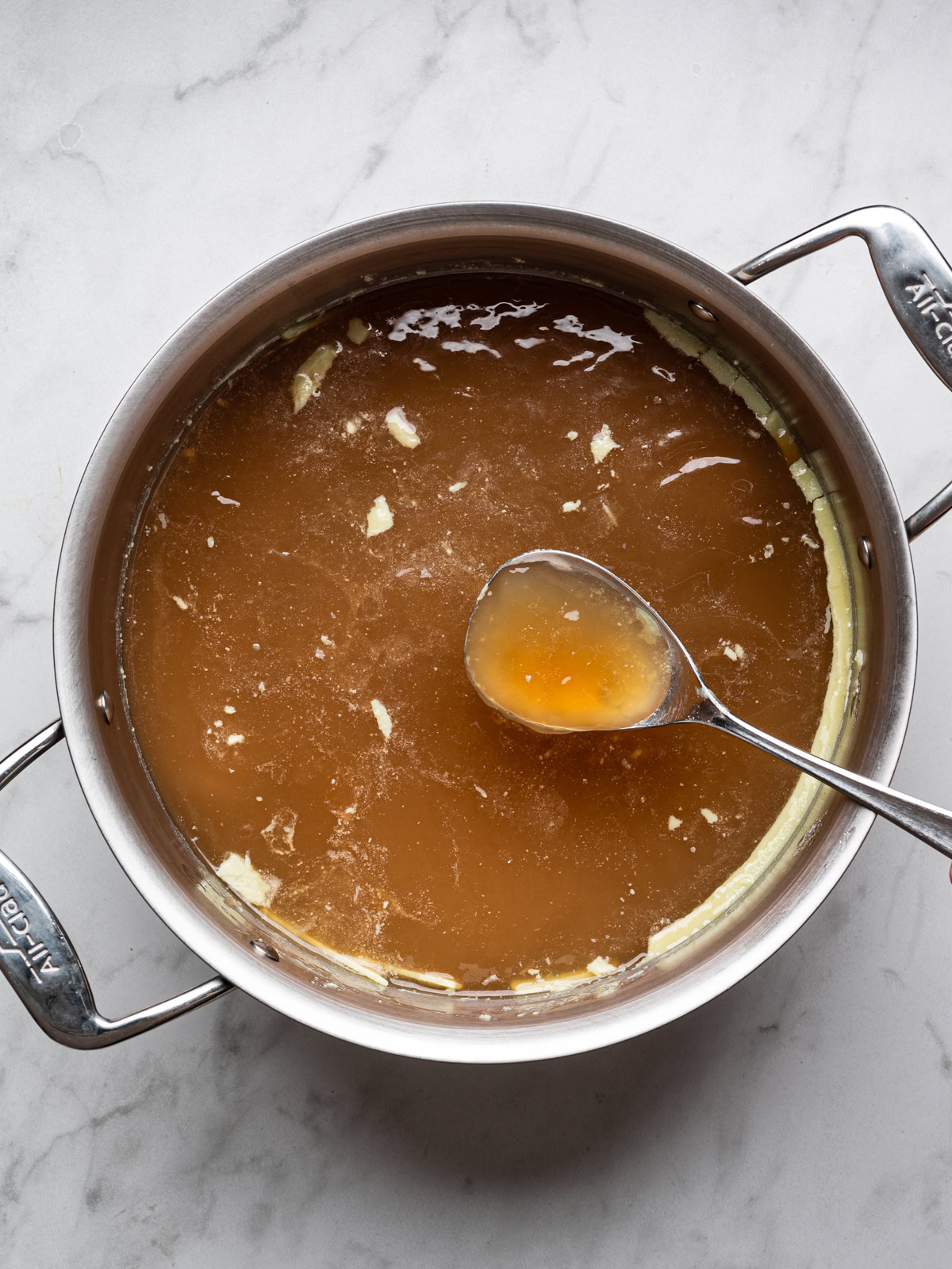 showing congealed broth in stainless steel pot