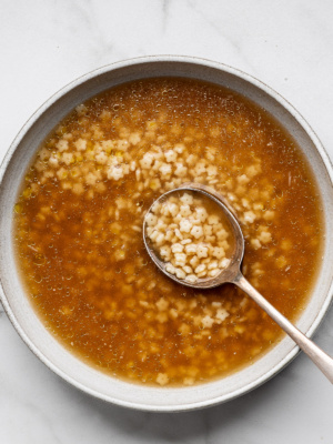 Top view of Pastina soup served in a bowl with a spoon