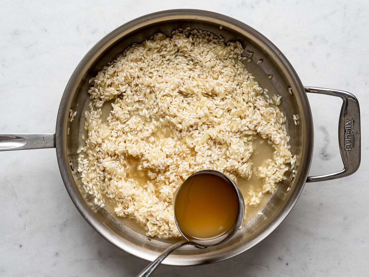 broth being ladled into the rice mixture 