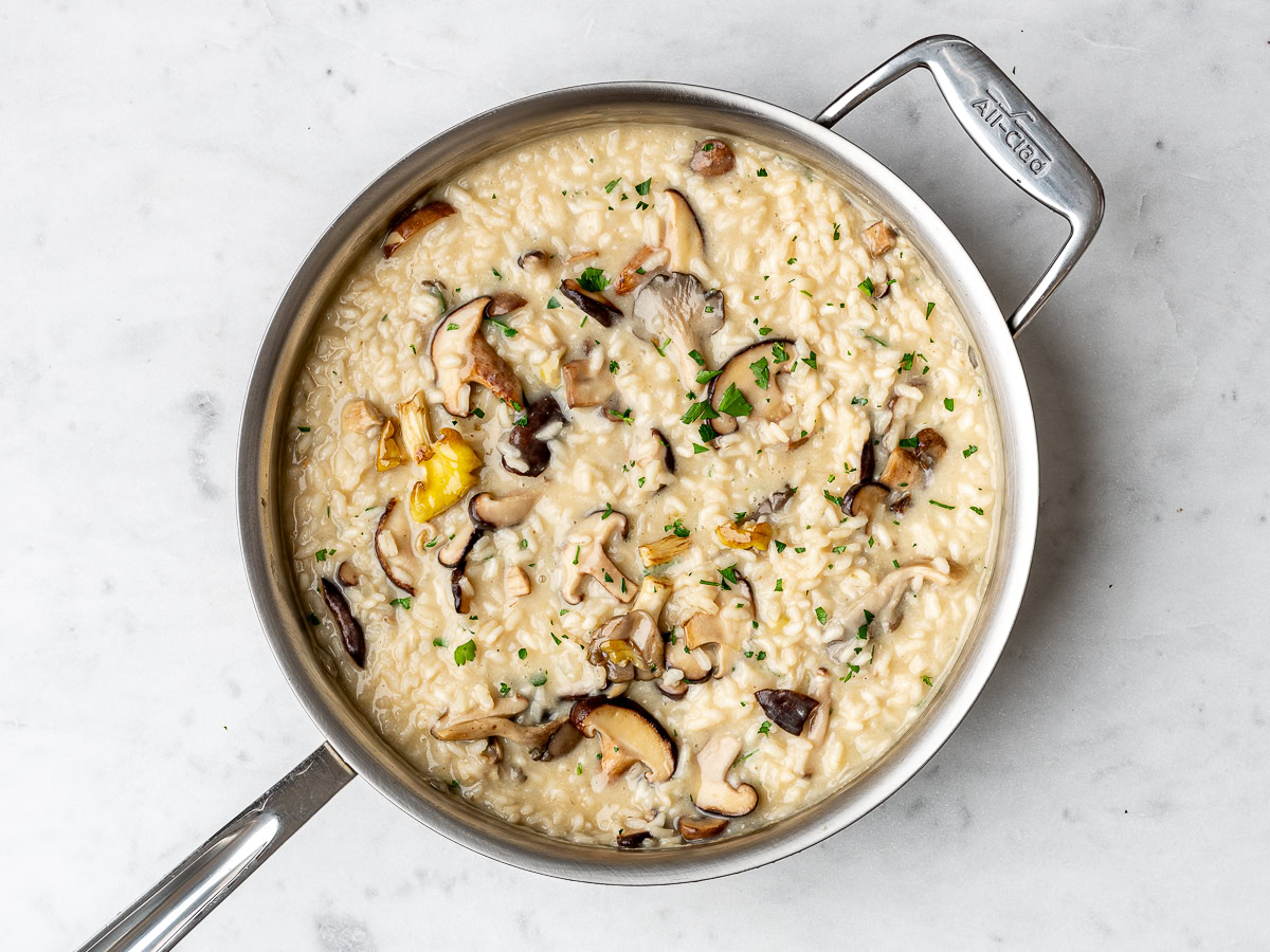 the finished mushroom risotto dish in the stainless steel pan