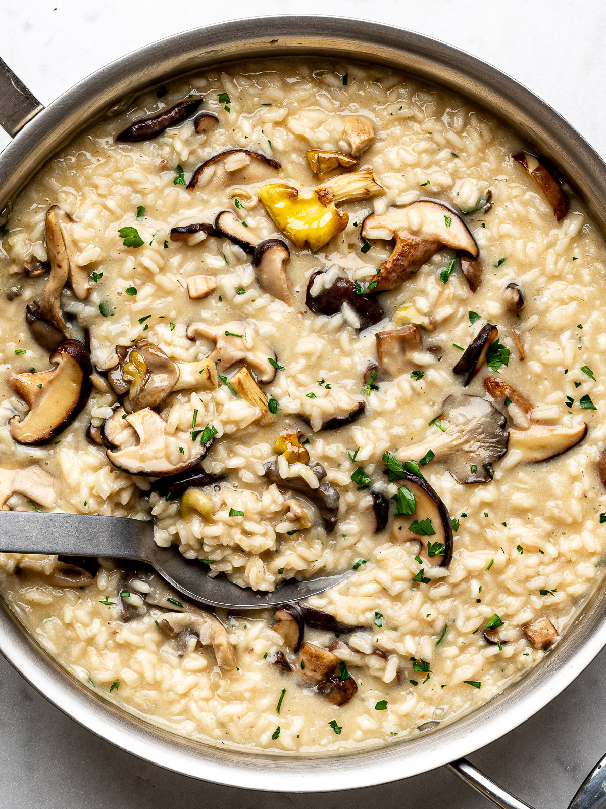 closeup of the finished mushroom risotto dish in the stainless steel pan