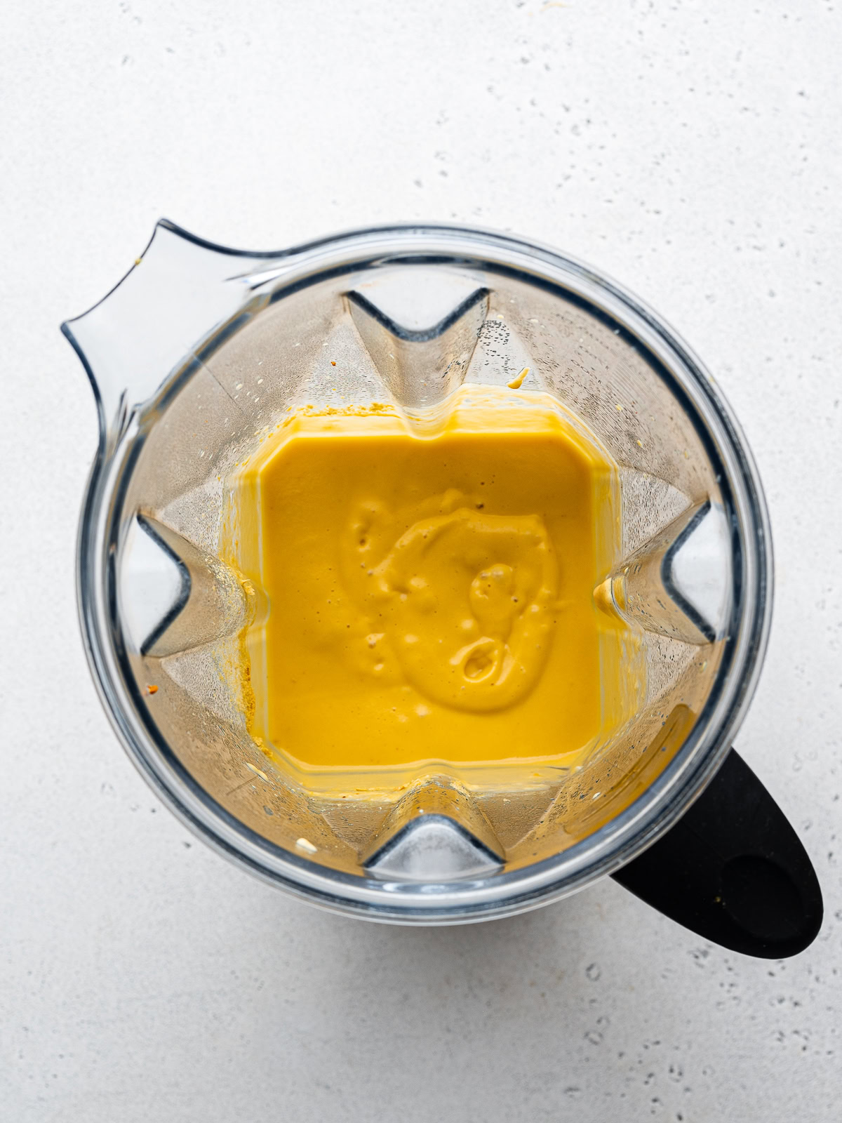 top-view of queso ingredients blended in blender jar