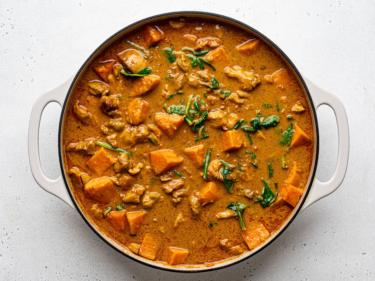 Cooked sweet potato curry in skillet without cilantro garnish