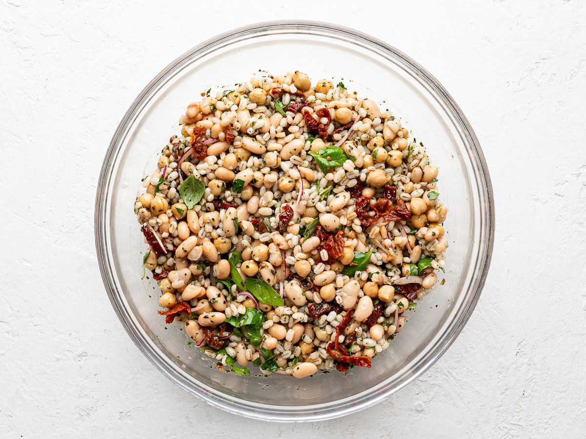 Bean salad tossed in glass mixing bowl.
