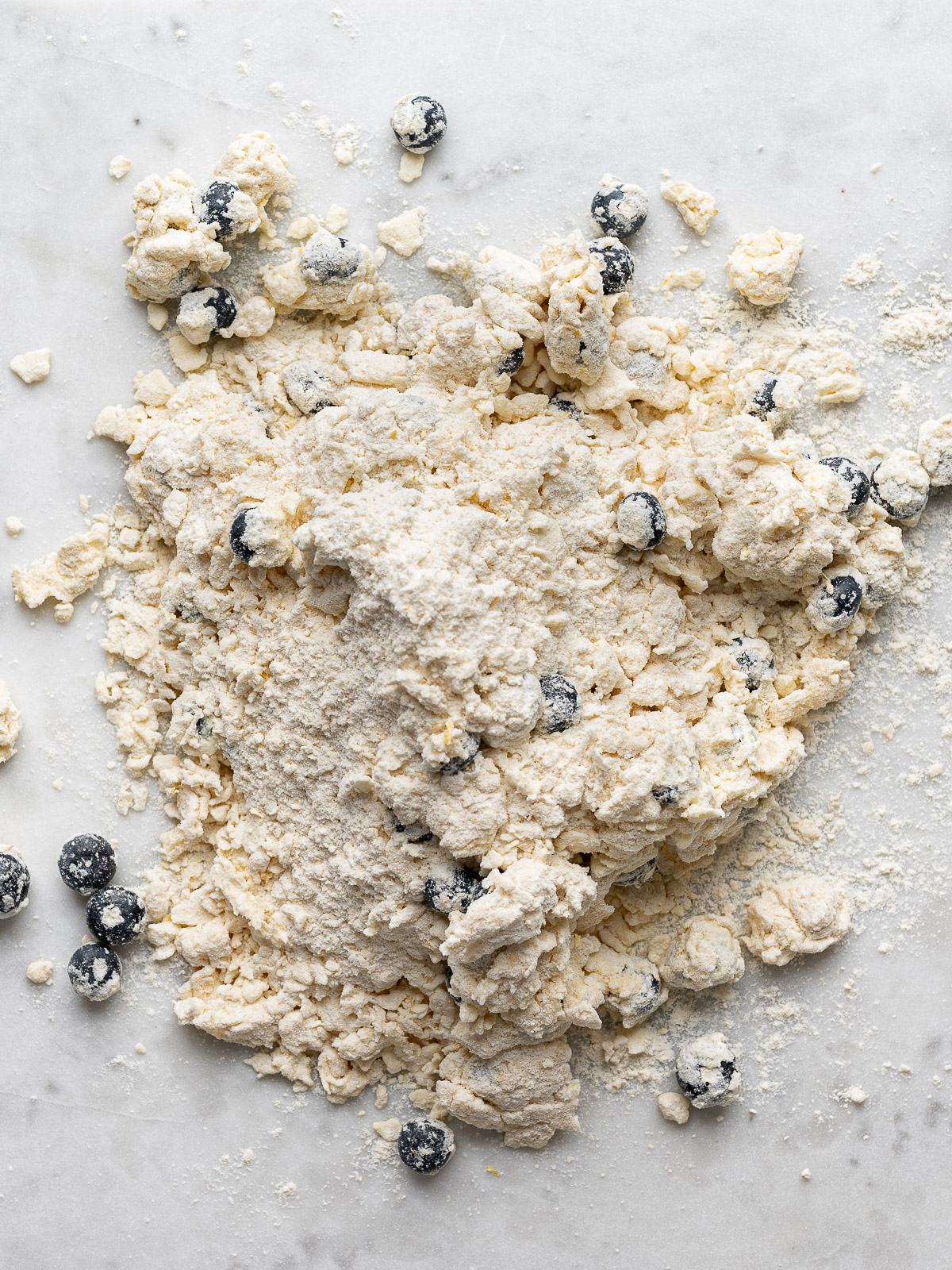 Unshaped shaggy dough on counter.