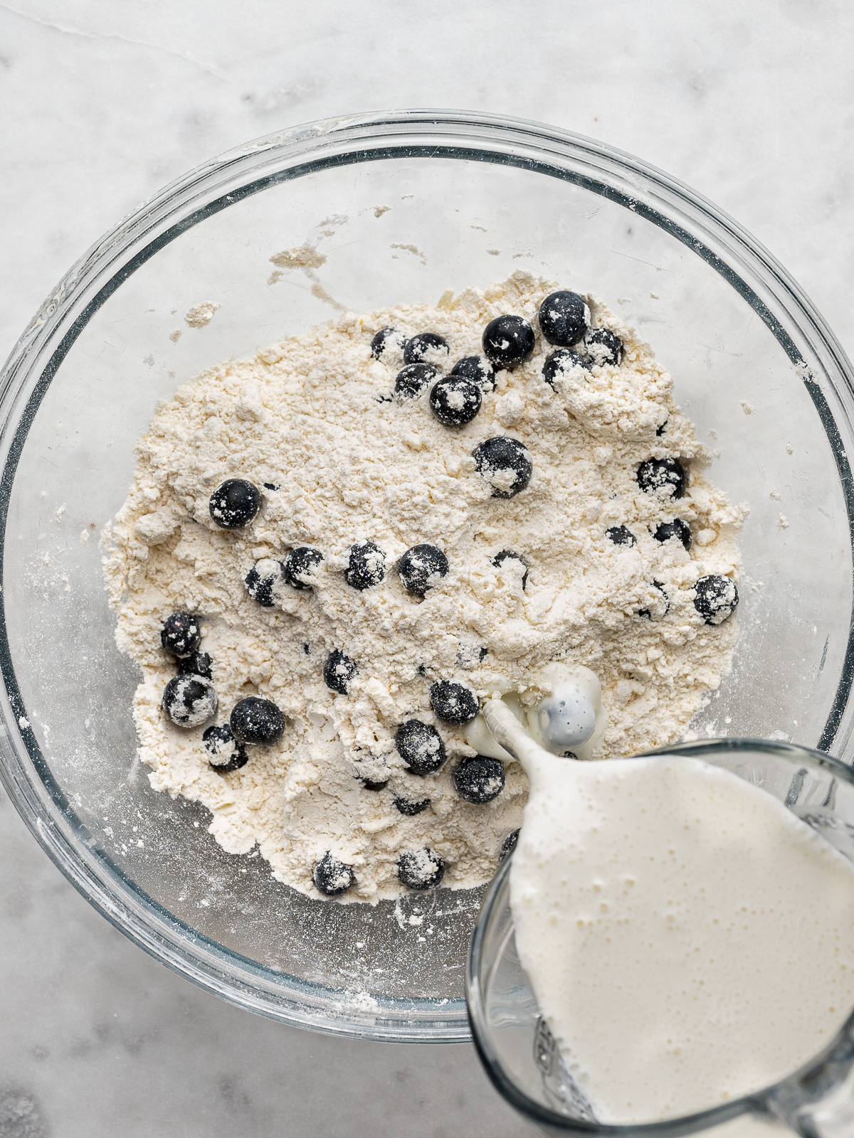 Adding wet ingredients to the dry ingredients.