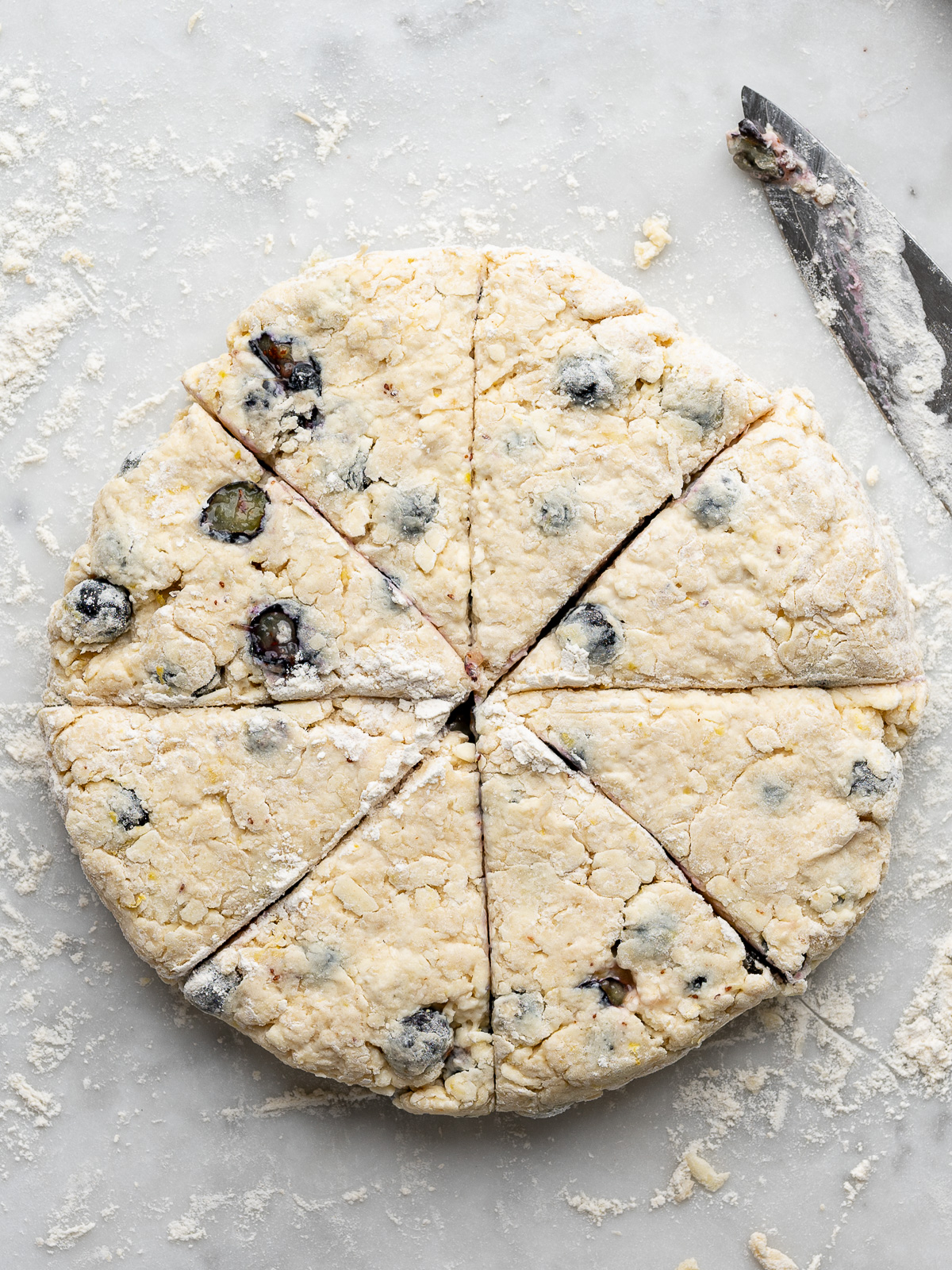 Dough disk sliced into 8 triangles.