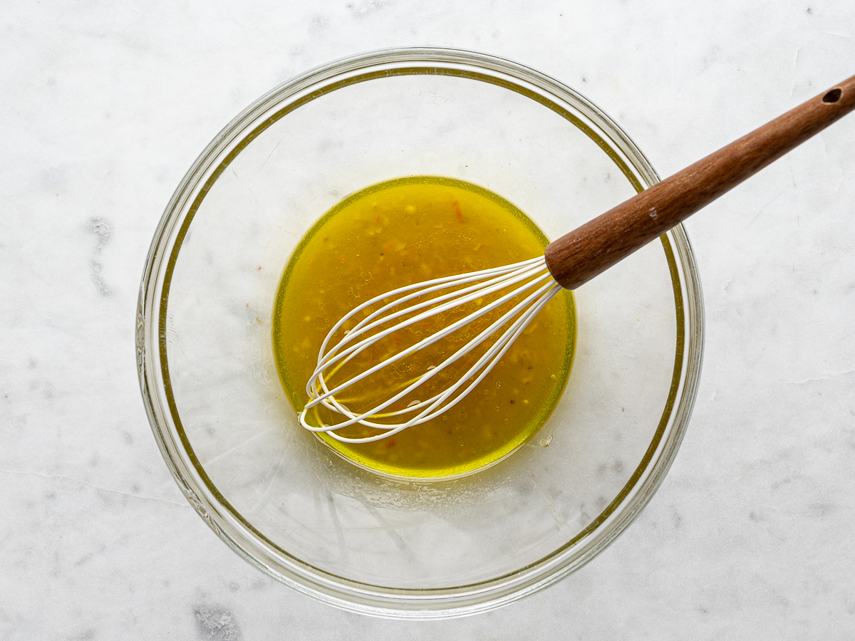 Mixed dressing in a large glass mixing bowl. 