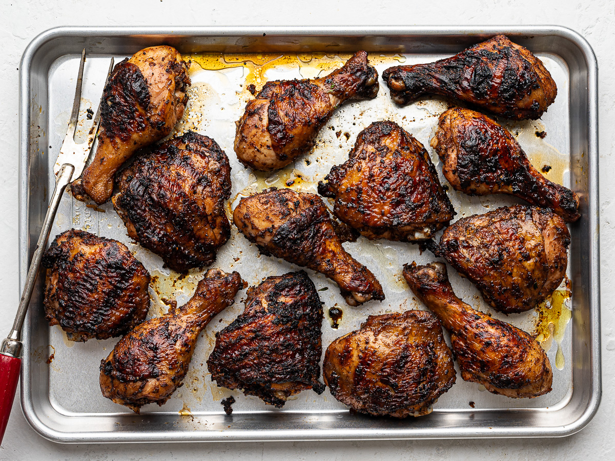 Grilled jerk-spiced chicken on a sheet pan. 