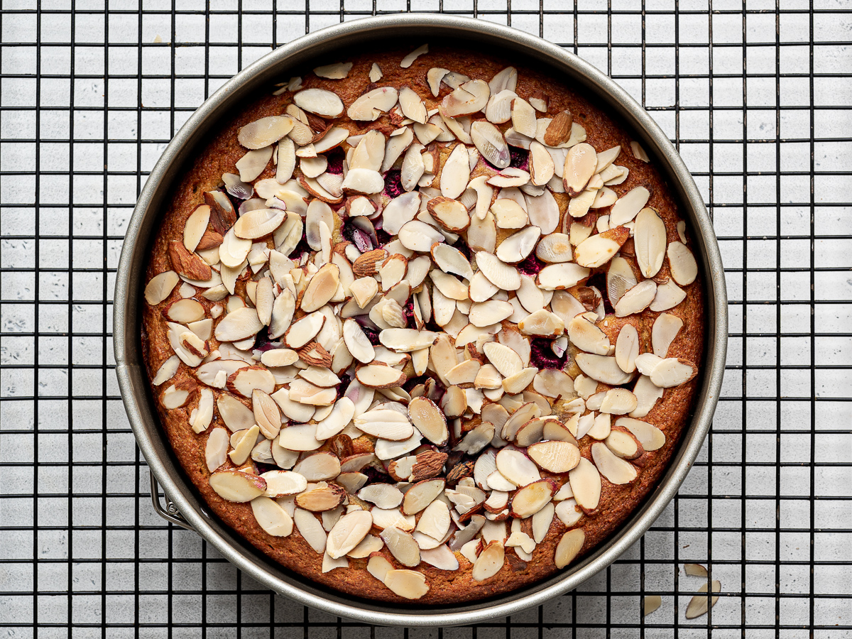 Raspberry Ricotta Almond Cake cooling on a wire rack. 