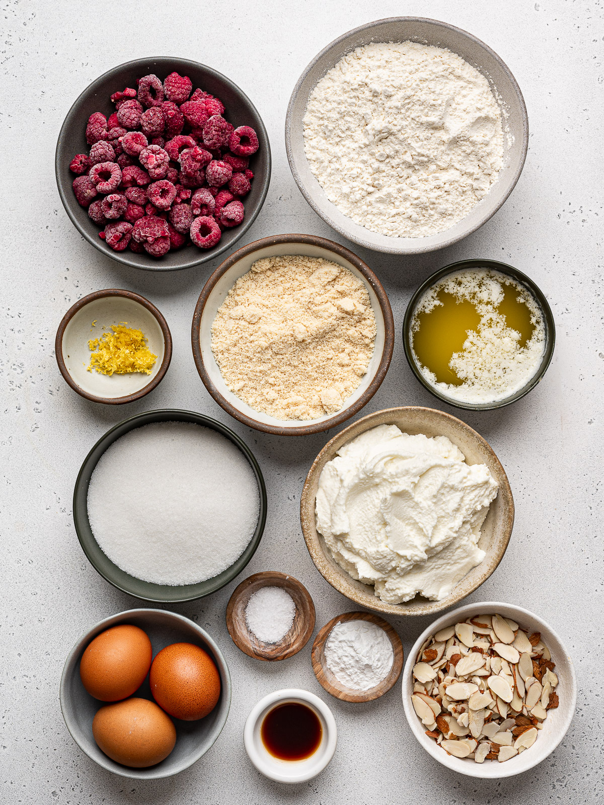 Ingredients for cake prepared in small bowls.