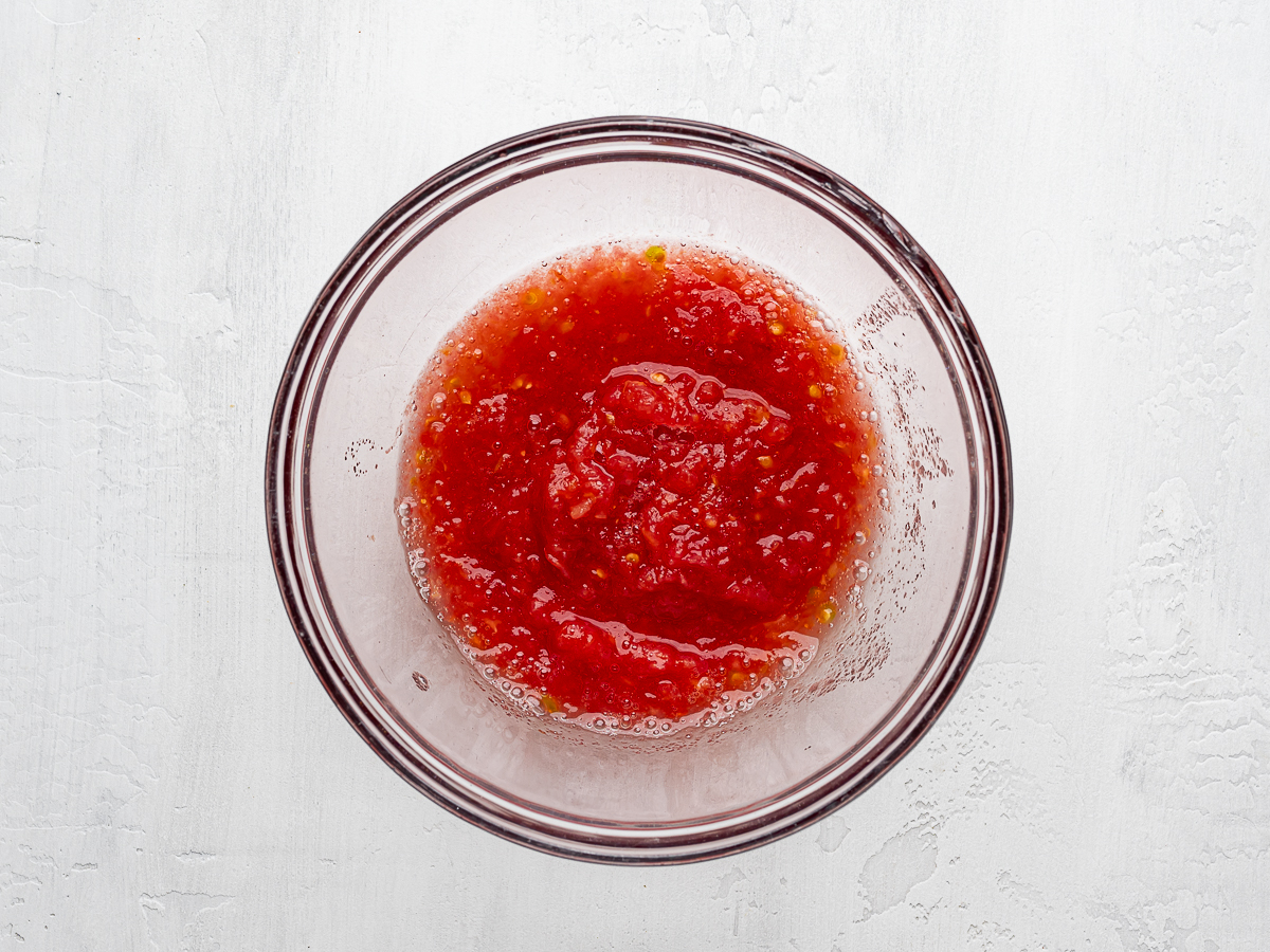 Grated tomato pulp in a glass bowl. 