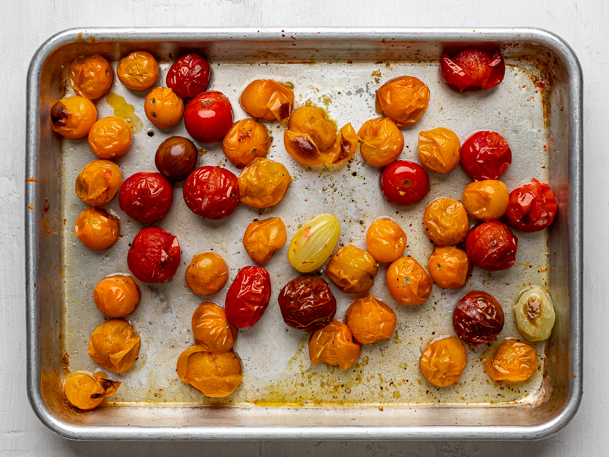 Roasted cherry tomatoes on sheet pan.