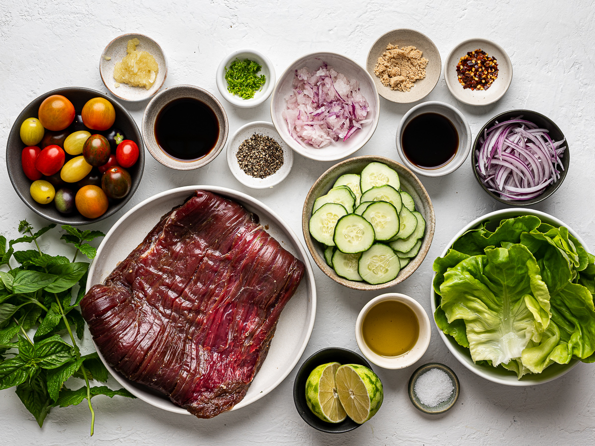 Ingredients for Thai-Inspired Steak Salad prepared in individual plates and bowls.