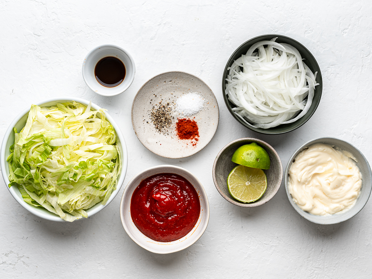 Ingredients for the lettuce and burger sauce topping prepared in bowls. 