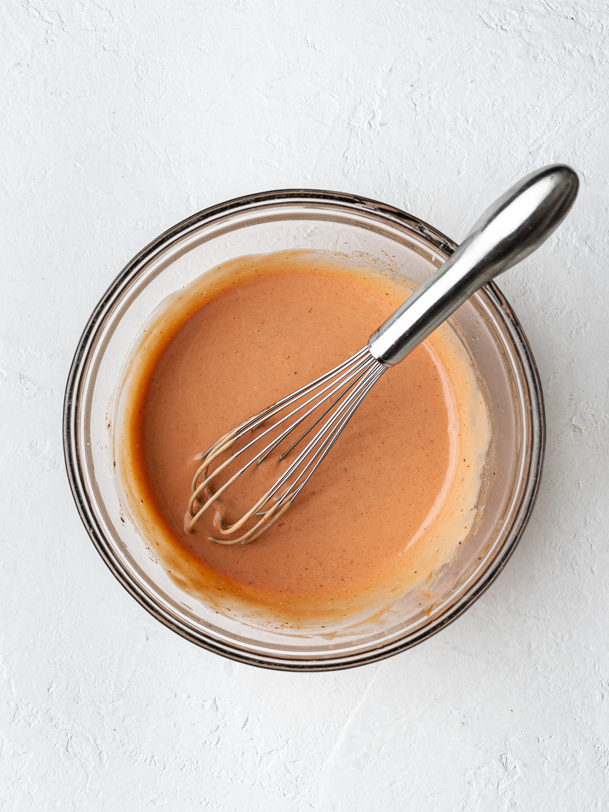 Burger sauce in a small glass mixing bowl.